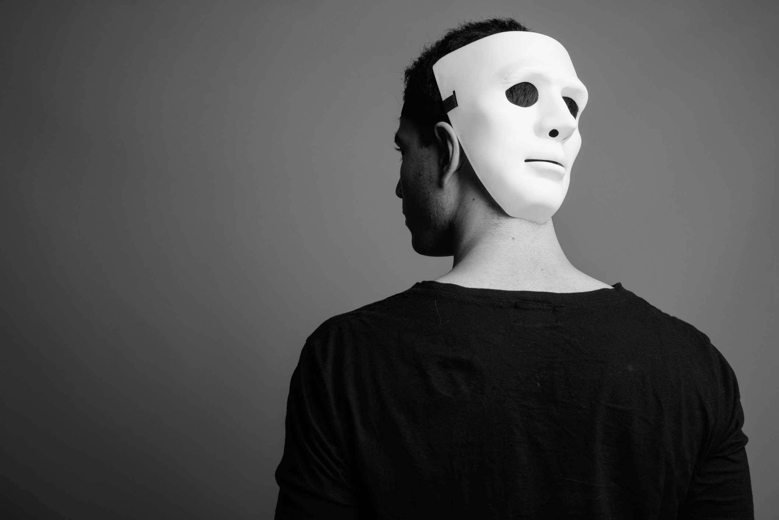Portrait of young Persian man wearing white mask