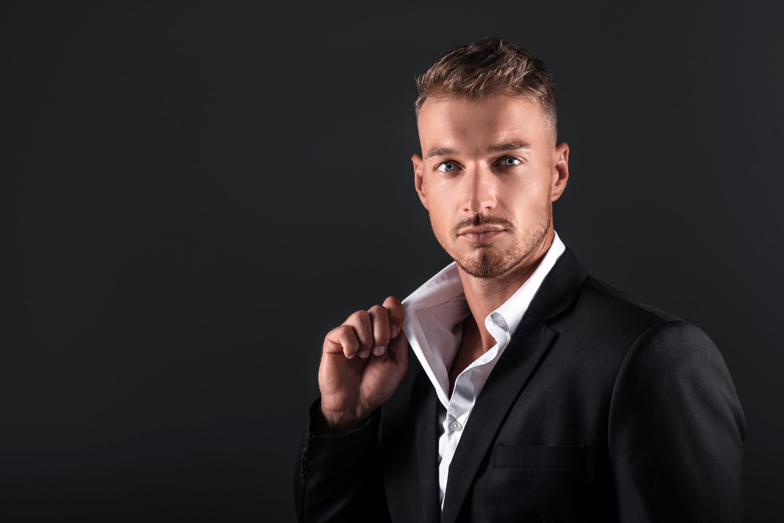 man in black studio portrait suit